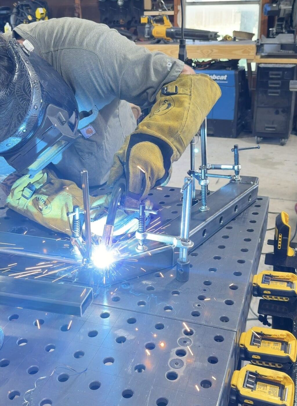 Peyton Sweet welding a steel part in the Sweets Fabrication shop